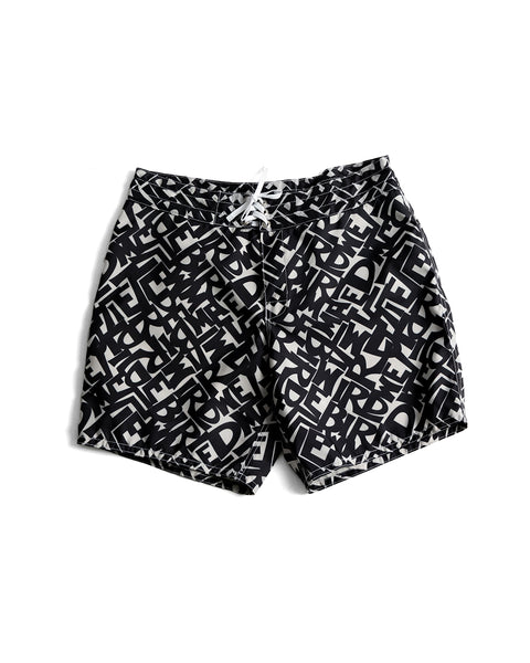 Front View of the Alphabet Soup Boardshorts. Pattern printed with black typography derived from the Birdwell logo. White drawstring with white stitching. White background.