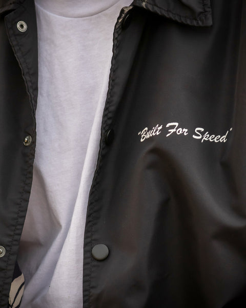 Close-up image of the jacket open with white t-shirt underneath. 