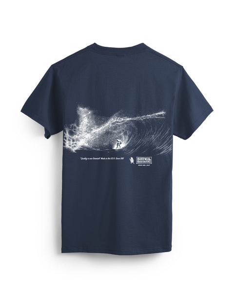 Back of Navy T-shirt on white background with white textural screenprint of surfer on a barrel wave. Beneath the graphic in an italic vintage text saying 