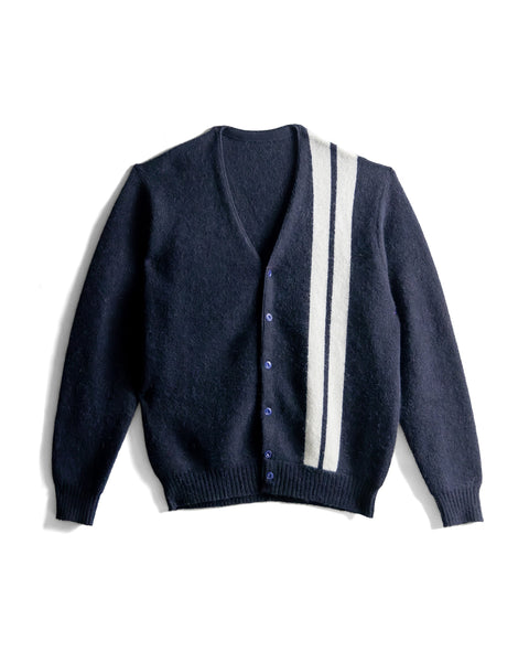 Flaylay of Comp Stripe Cardigan, navy blue cardigan with two vertical white stripes from left shoulder down to bottom ribbing on white background.