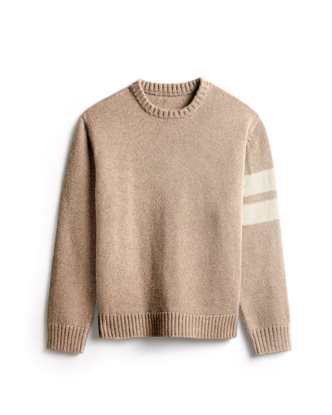 Oatmeal colored sweater with two horizontal cream stripes on the left arm. Ribbing at collar, sleeves and bottom of sweater. White background.