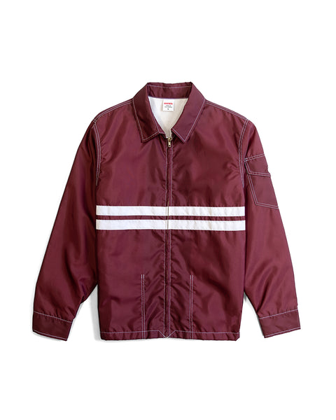 Front view of Competition Jacket in Burgundy with two horizontal white stripes with white contrast stitching on white background.