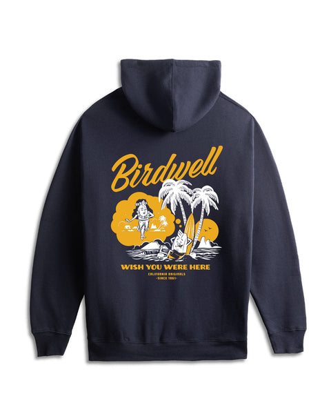 Flatlay of back of the navy hoodie. Graphic in yellow and white of daydreaming birdie leaning against a surfboard under two palm trees dreaming of hula birdie.