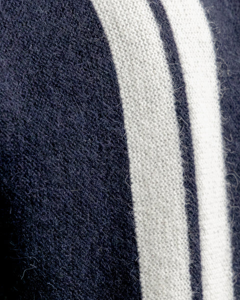 Detail closeup of the Comp Stripe Cardigan fabric. Showing soft fabric fibers and two white stripes on the navy fabric.