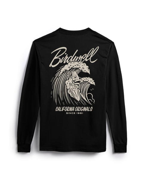 Back view of black long sleeve shirt with Drop In Screen Printed Graphic in Milk. Screen Printed Graphic features Birdie surfing on a wave while holding up a peace sign. Birdwell logo in script above the wave with California Originals since 1961 below. T-shirt on white background.