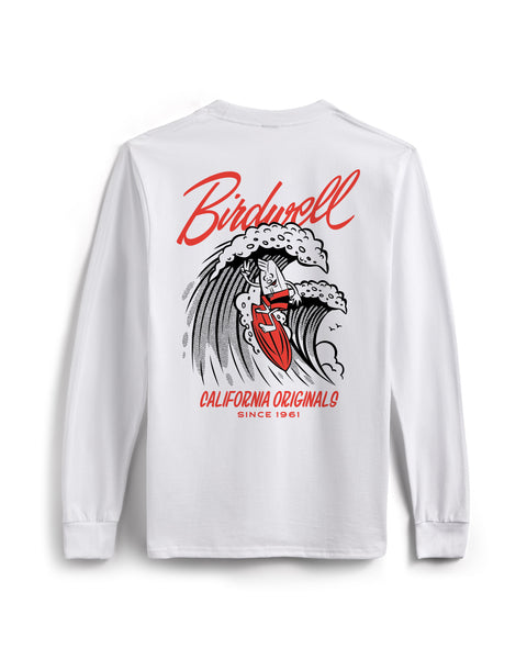 Back view of white long sleeve shirt with Drop In Screen Printed Graphic in black and red. Screen Printed Graphic features Birdie surfing on a wave while holding up a peace sign. Birdwell logo in script above the wave with California Originals since 1961 below. T-shirt on white background.