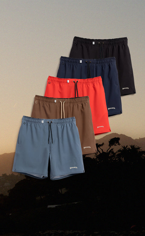 Wright Lined Shorts in Slate, Tobacco, Red, Navy and Black sitting over a sunrise background.
